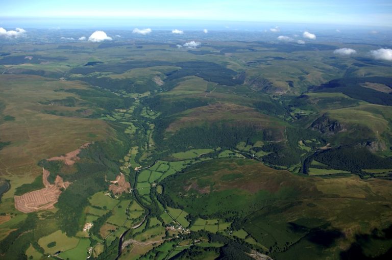An aerial view of farmlands, forests and countryside